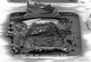 Some of the damage Caltech engineers intentionally inflicated on their self-healing power amplifier using a high-power laser. The chip was able to recover from complete transistor destruction. This image was captured with a scanning electron microscope. Image: Jeff Chang and Kaushik Dasgupta.