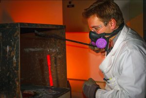 Professor Emmanuel De Moor performing heat treatments of machined tensile specimens using molten salt to provide fast and controlled temperature changes to match the “Quench & Partitioning” processing requirements. Image: Colorado School of Mines.