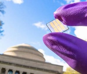 Researcher displays a sample of the record-setting new solar cell on the MIT campus. Photo courtesy of Chia-Hao Chuang.