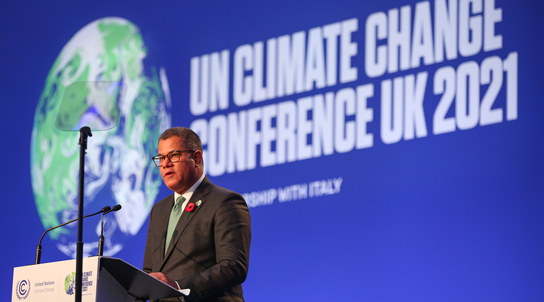 A speaker at a podium at COP26