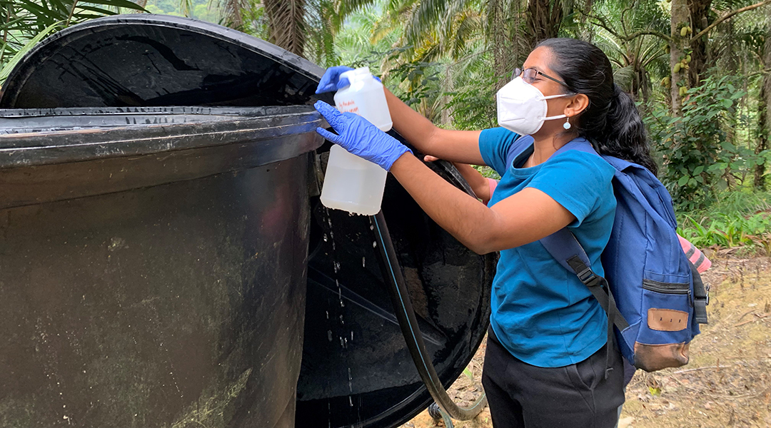 Geehta Maniam collects water samples in an Indigenous village