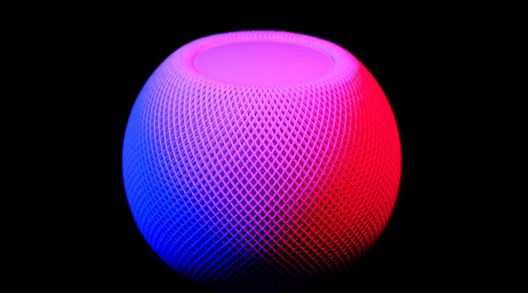 Robotic speaker on a black background.