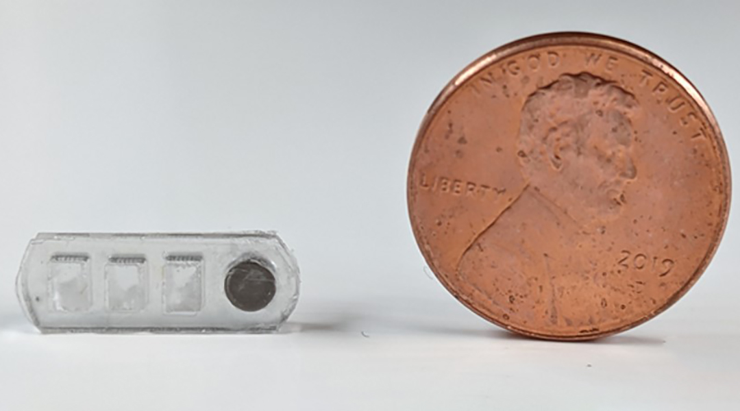 A robotic pill to explore the GI tract next to a penny for scale