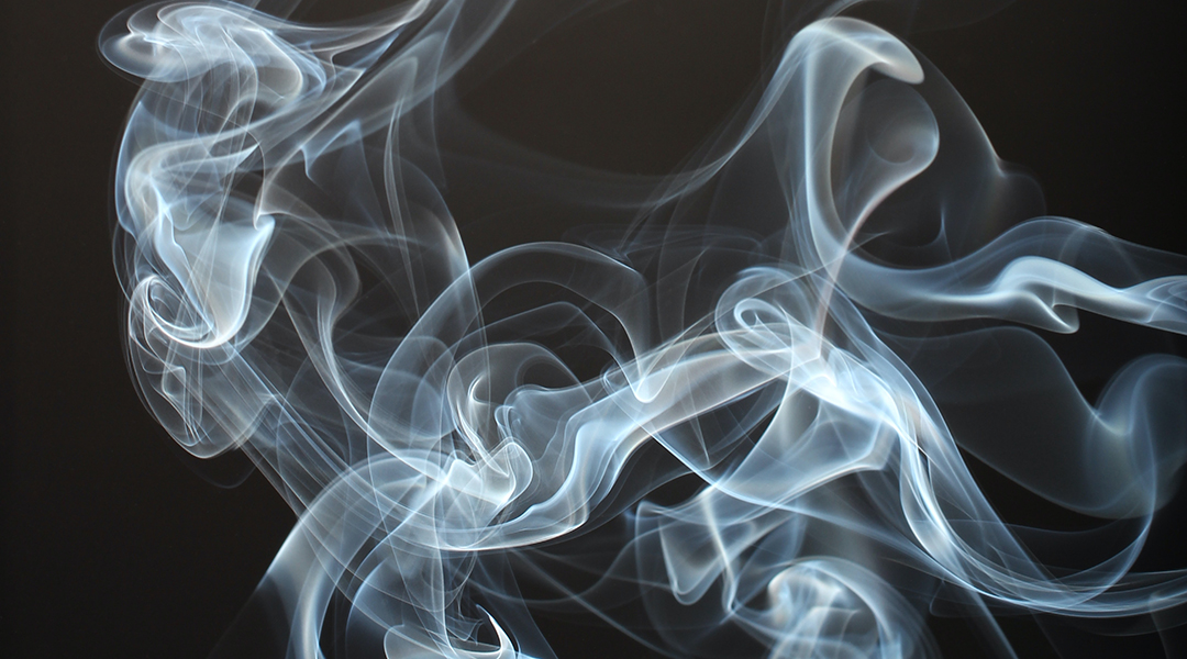 A puff of smoke against a black background.