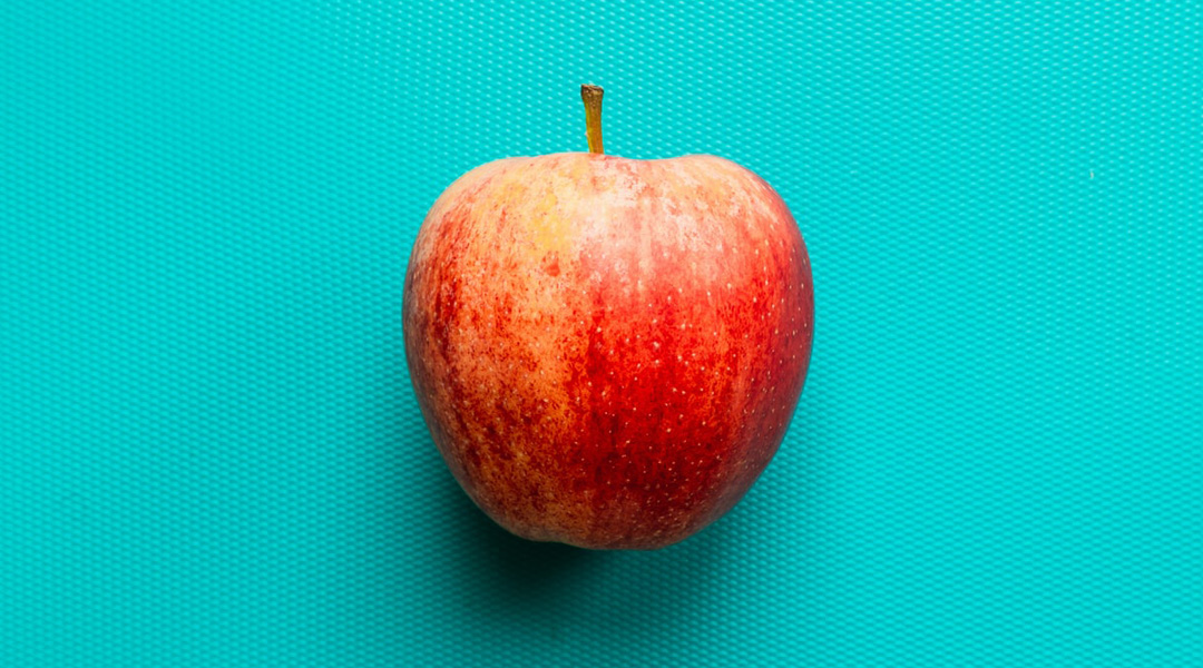 An apple on a blue background.
