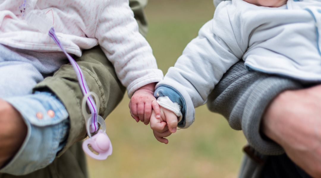 Two children holding hands.