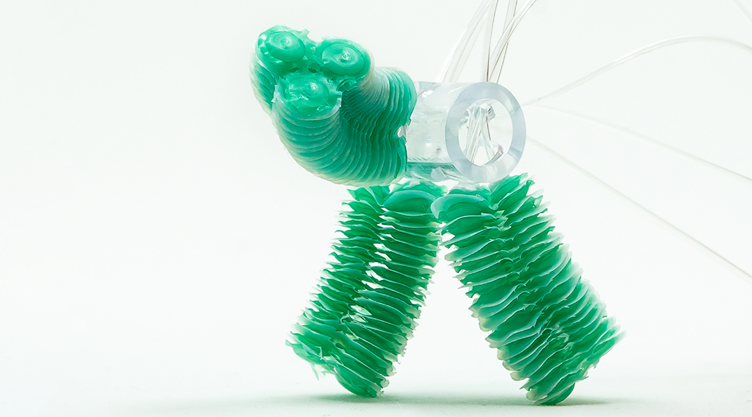 Soft robot made from balloon actuators on a white background