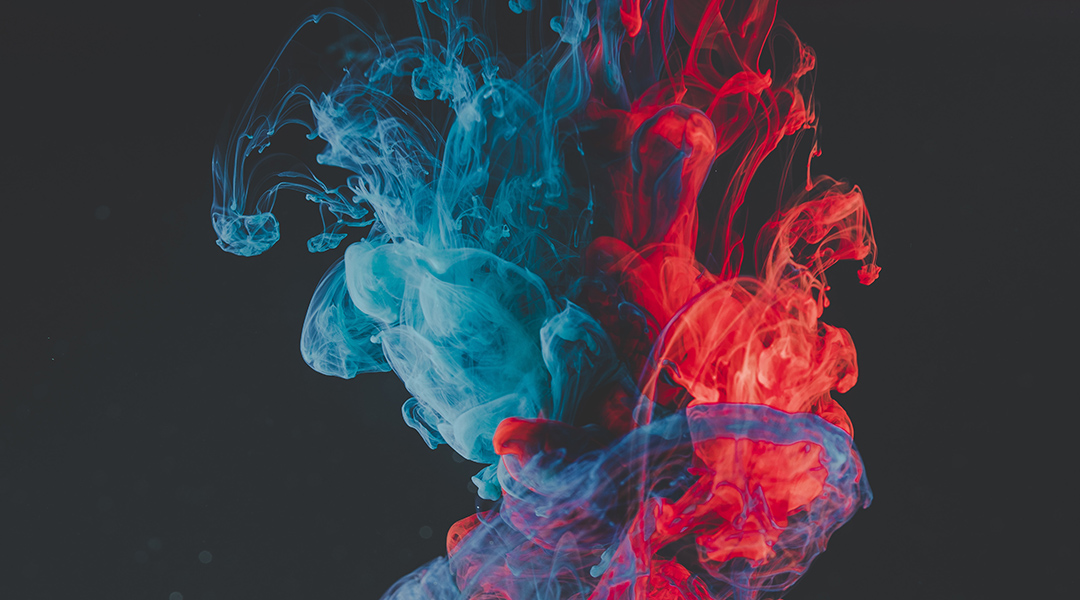 A cloud of colorful gas on a black background.