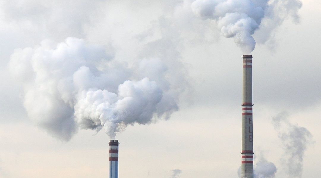 Two stacks emitting white gases into the atmosphere.