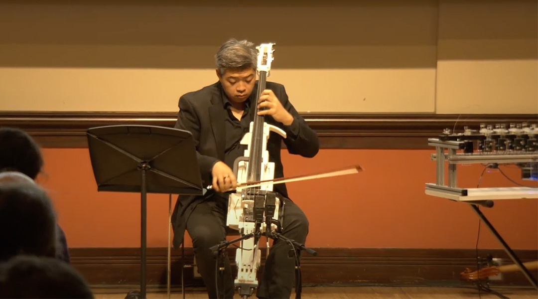 A man plays a 3D printed cello.
