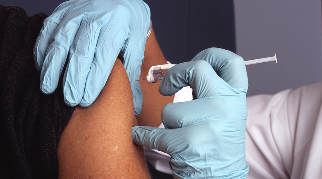 A vaccine being administered into a person's arm.