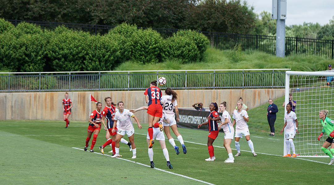 Women's soccer team playing soccer.