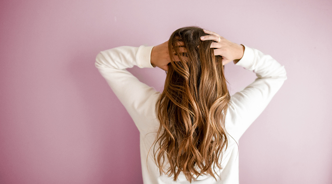 Woman running her fingers through her hair.