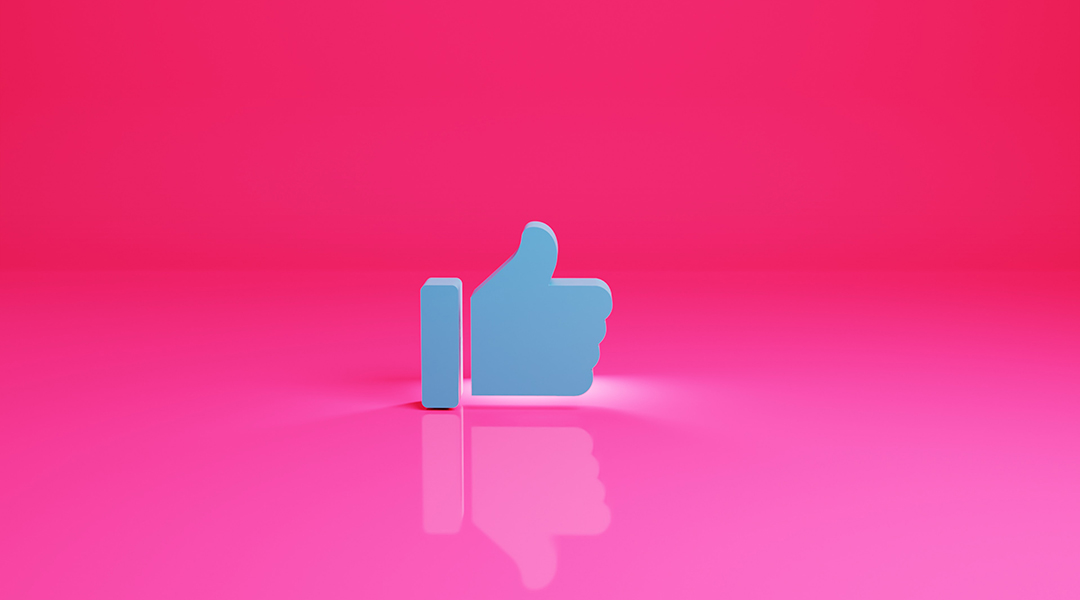 Facebook like button on a pink background.