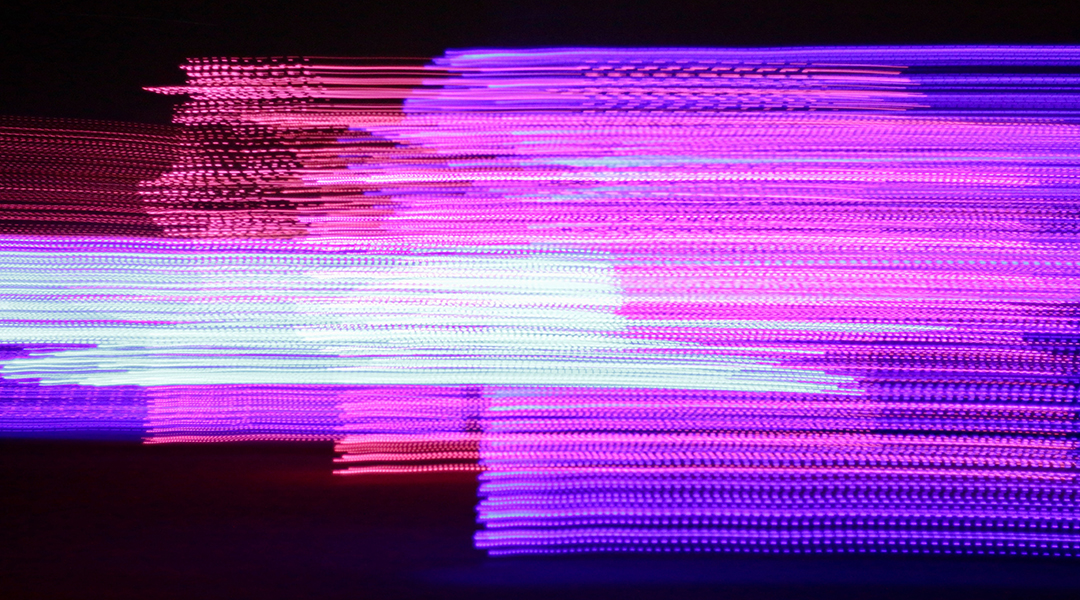 Abstract purple and red lights on a black background.