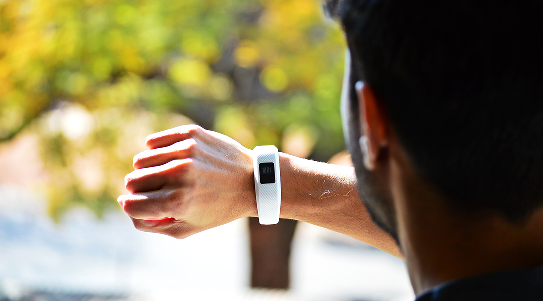 A man looking at a fitness tracker