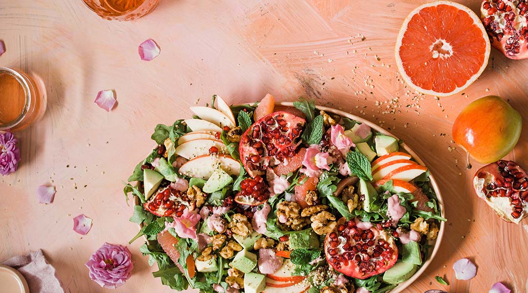 Picture of a salad on a pink background.