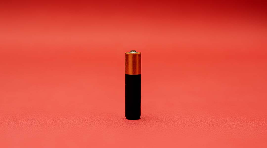 Battery on a red background.