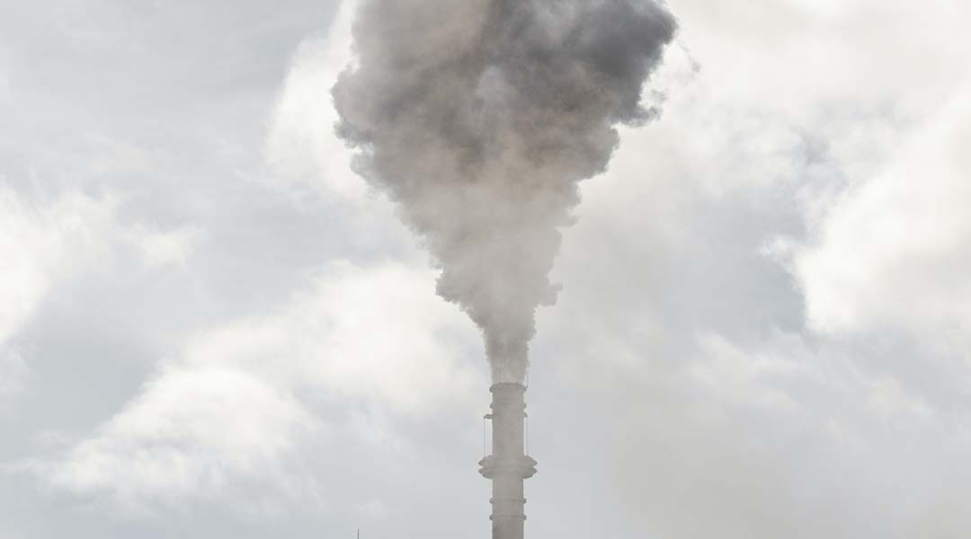 A smoke stack emitting vapors.
