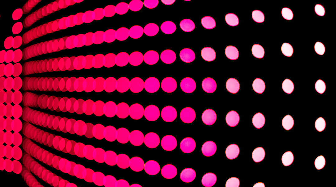 Pink dots on a black background.