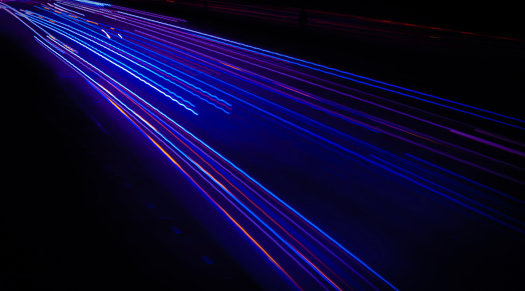 Abstract image of laser pulses on black background.