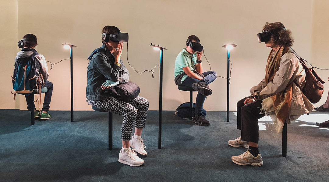 People in a museum using virtual reality.