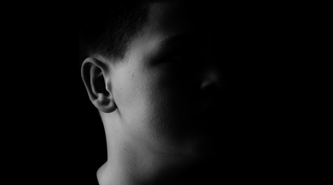 A black and white image of a young boy.