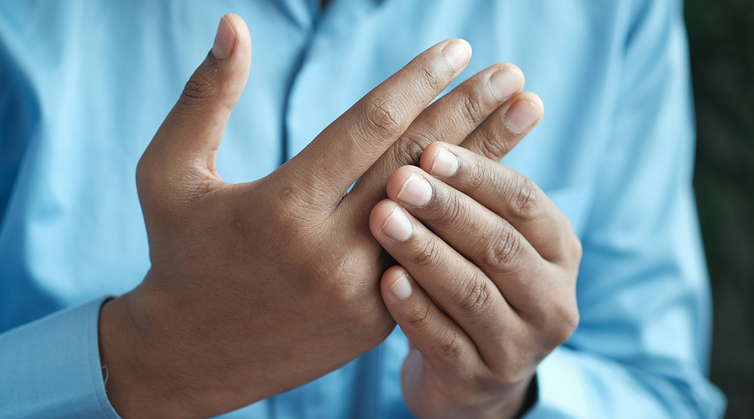 A person massaging their hands due to pain.