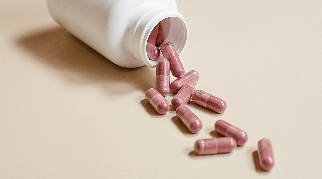 Supplement pills on a beige background.