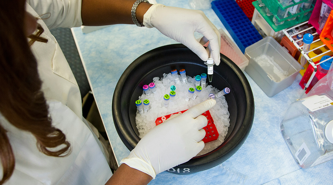 A scientist handling samples in a lab.