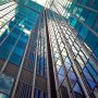 glass skyscrapers against a blue sky.