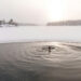 A woman taking a cold plunge.