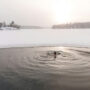 A woman taking a cold plunge.