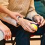 Older person holding a stress ball.