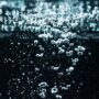 Dark background with microphotography of water bubbles